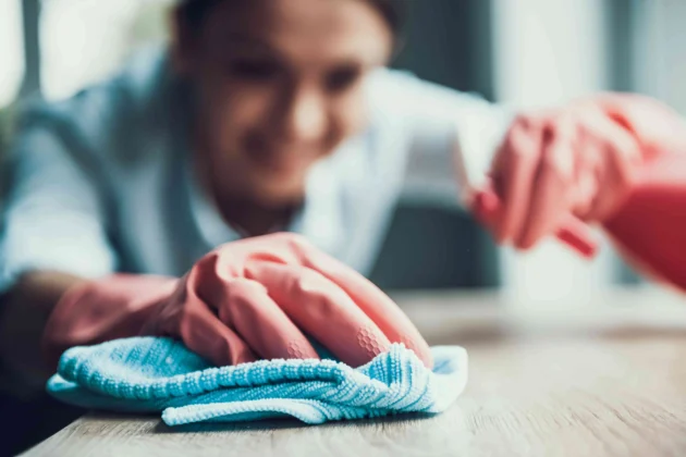 Woman cleaning granite countertop