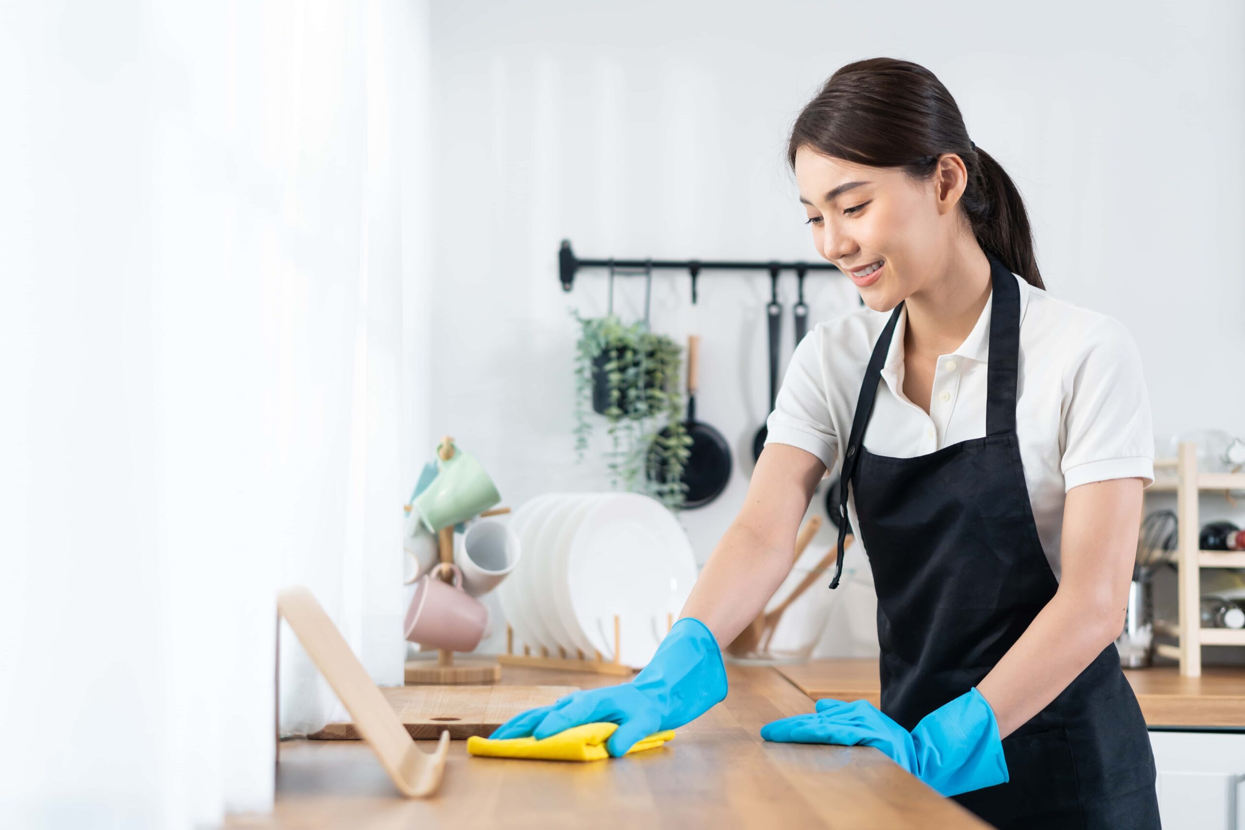 Woman cleaning the kitchen in a beautiful large house